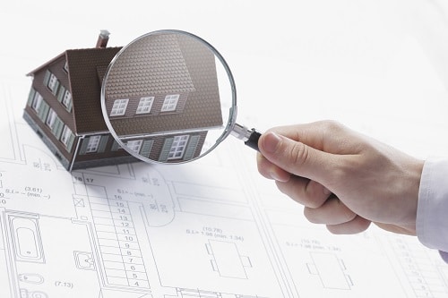 Magnifying glass and house.