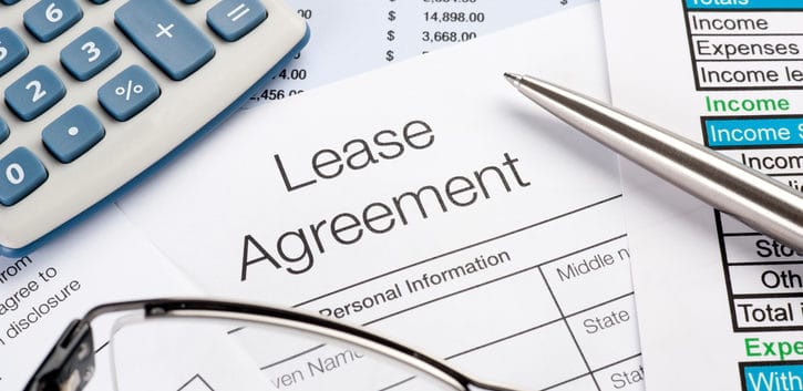 Lease Agreement Form with pen, calculator