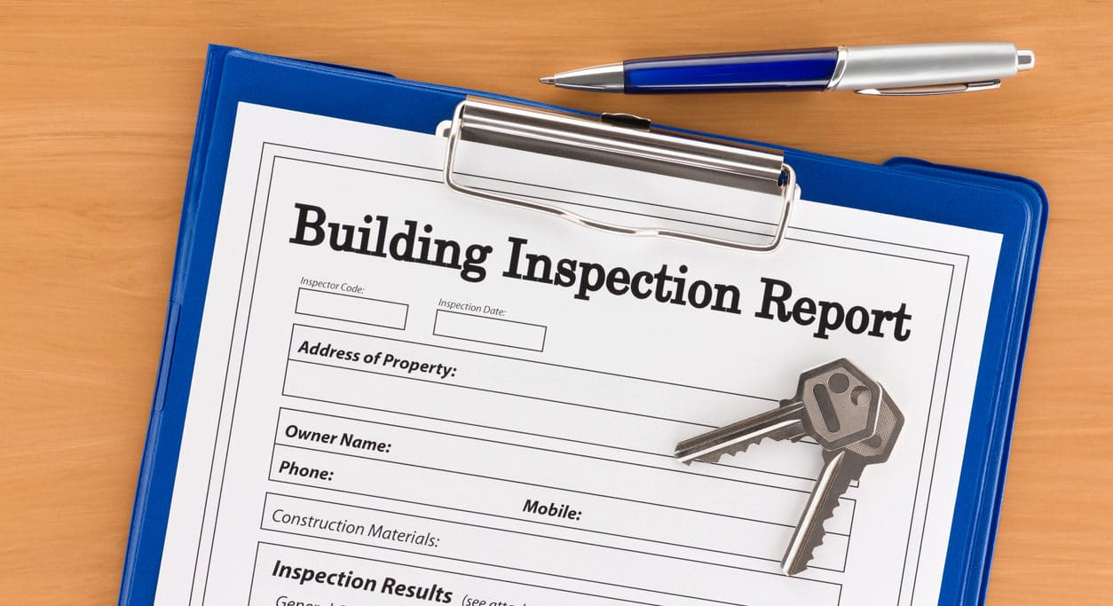 Building Inspection Report with Pen and Keys