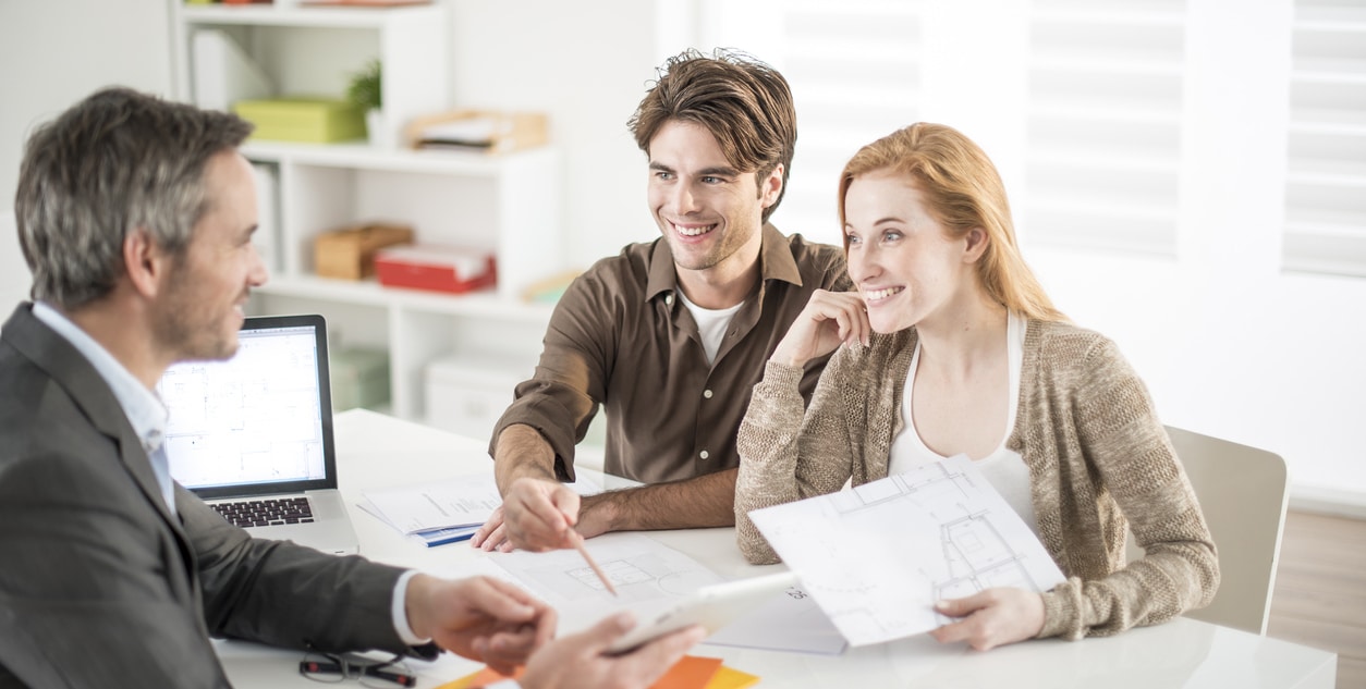 real-estate agent receives a young couple interested to invest i