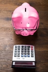 Piggybank With Calculator On Table