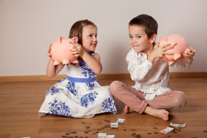 Children Holding Their Piggy Bank 300x200